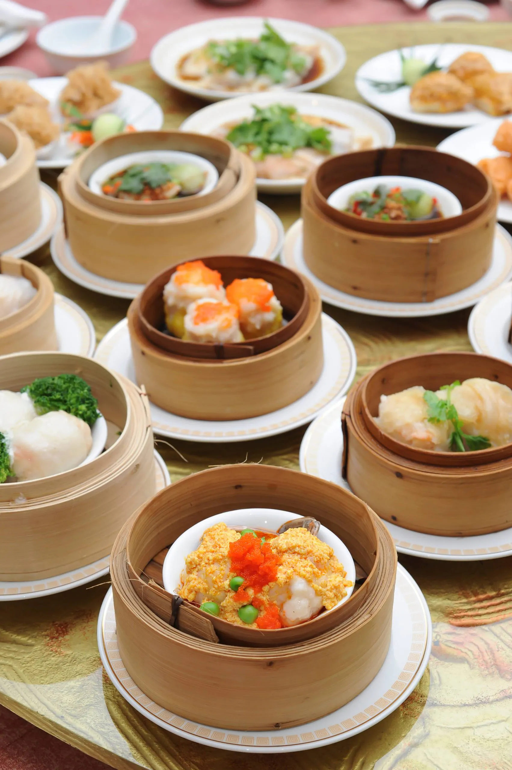 Assorted dim sum dishes served in bamboo steamers on a restaurant table